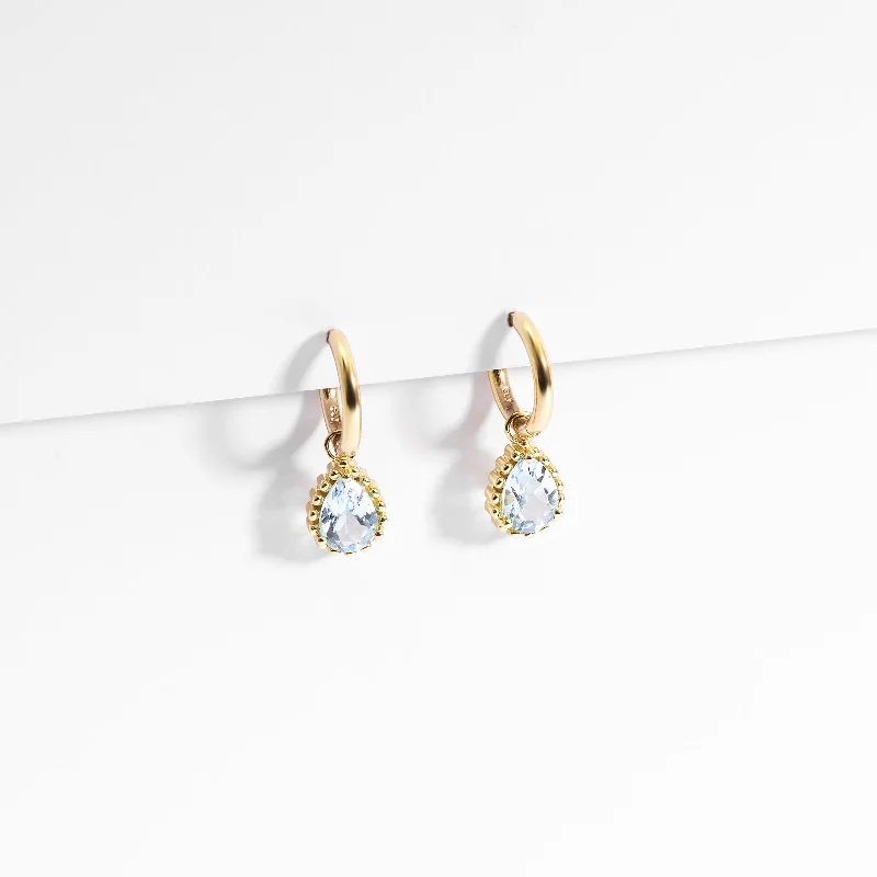 9K Yellow Gold Huggie Earrings With Dangling Blue Topaz Pear